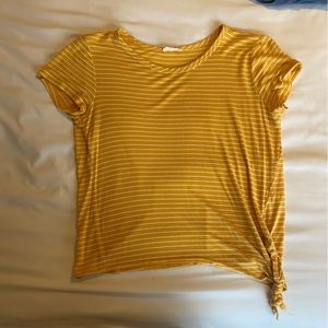 Yellow striped top. Knotted in the front.